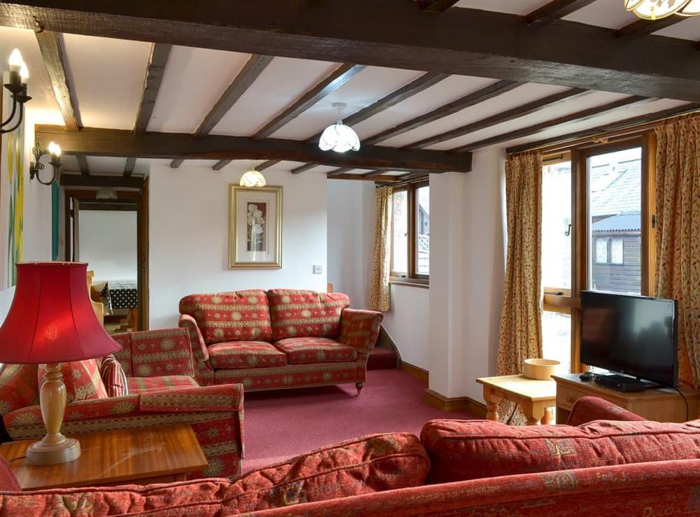 Characterful living room with beamed ceiling at Duvale Barn, 