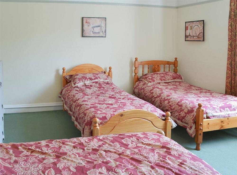 Spacious bedroom with a double and two single beds (photo 2) at Duvale Priory in Bampton, near Tiverton, Devon