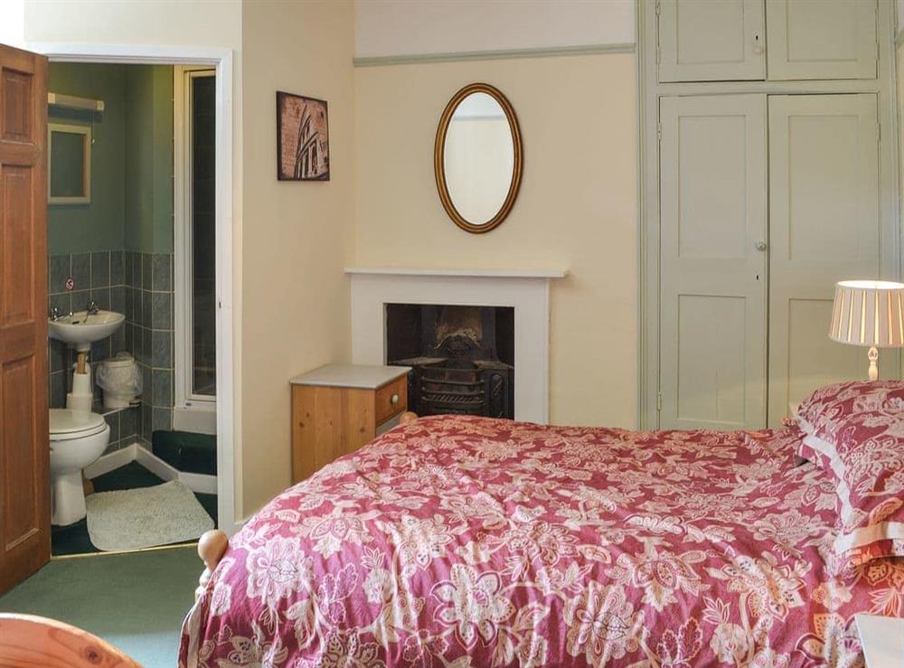Spacious bedroom with a double and two single beds at Duvale Priory in Bampton, near Tiverton, Devon