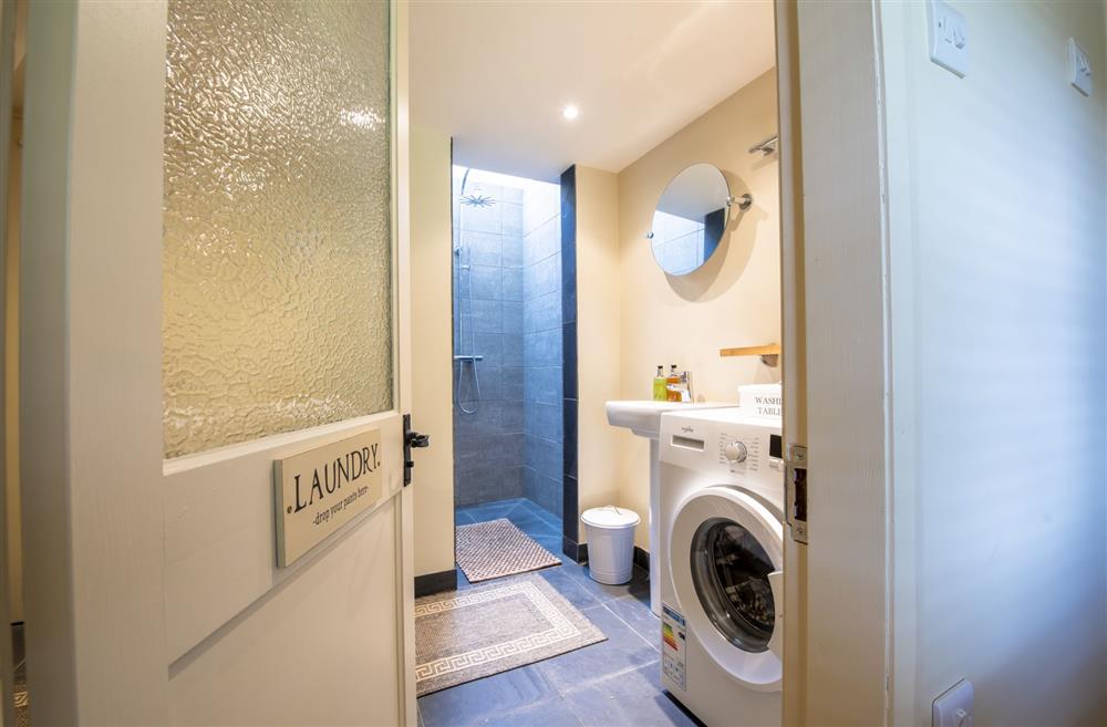 Laundry room and cloakroom featuring walk-in shower