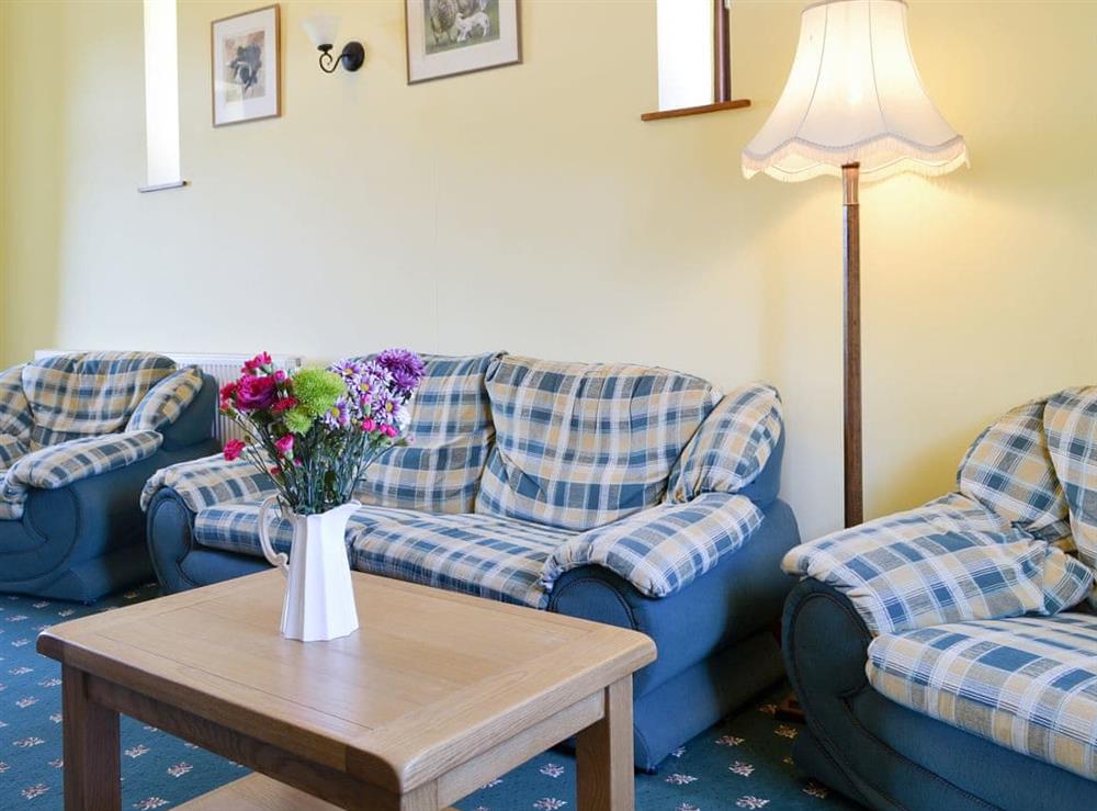 Comfy seating within the living and dining room at Dwyfor in Llanystumdwy, Criccieth, Gwynedd