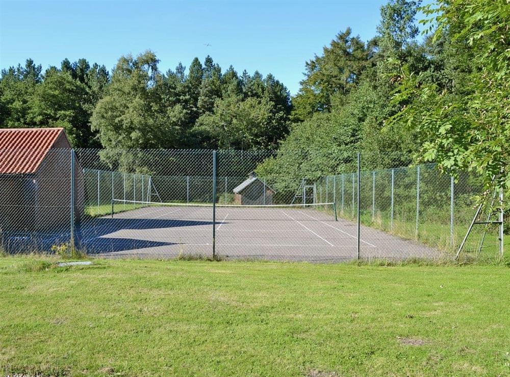 An outdoor tennis court at Dyes Cottage in Hindolveston, near Holt, Norfolk