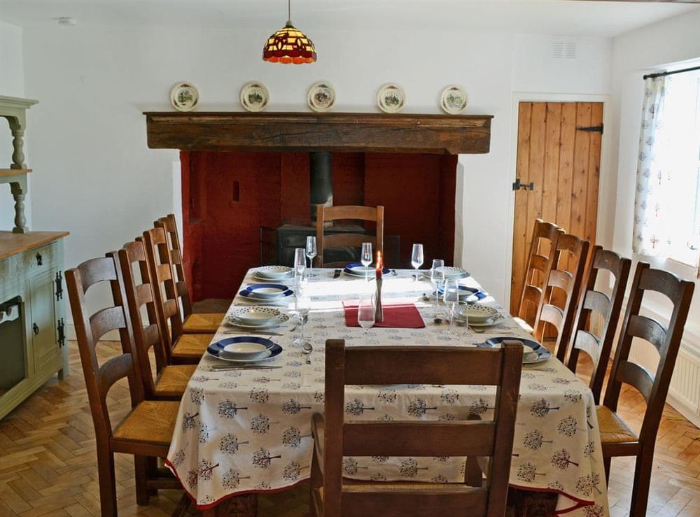 Large dining room with a woodburner at Dyes Cottage in Hindolveston, near Holt, Norfolk