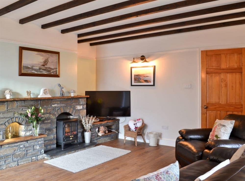 Living room with wood beamed ceiling at Dyffryn Haidd in Llanafan, near Aberystwyth, Dyfed