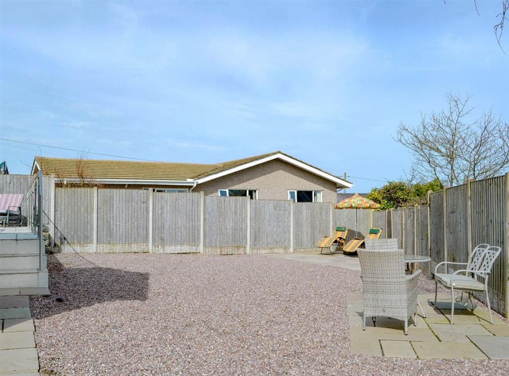 Spacious grounds with sitting out area (photo 2) at Dylmor in Benllech , North Wales, Gwynedd