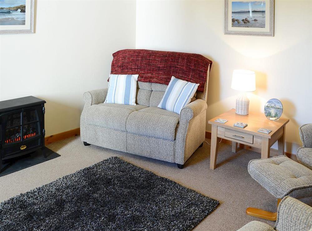 Lovely comfortable living room with electric wood burner at Eagle Cottage in near Culkein, Northern Highlands, Sutherland
