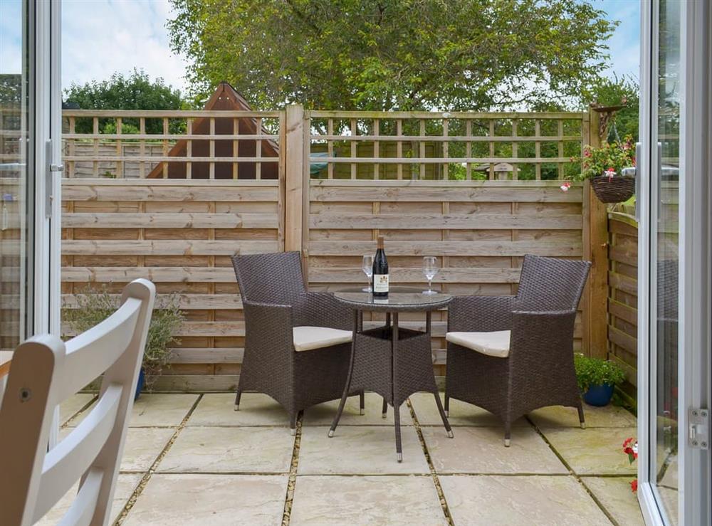 Courtyard with sitting-out area and garden furniture at Eagles Cottage in Corston, near Malmesbury, Wiltshire