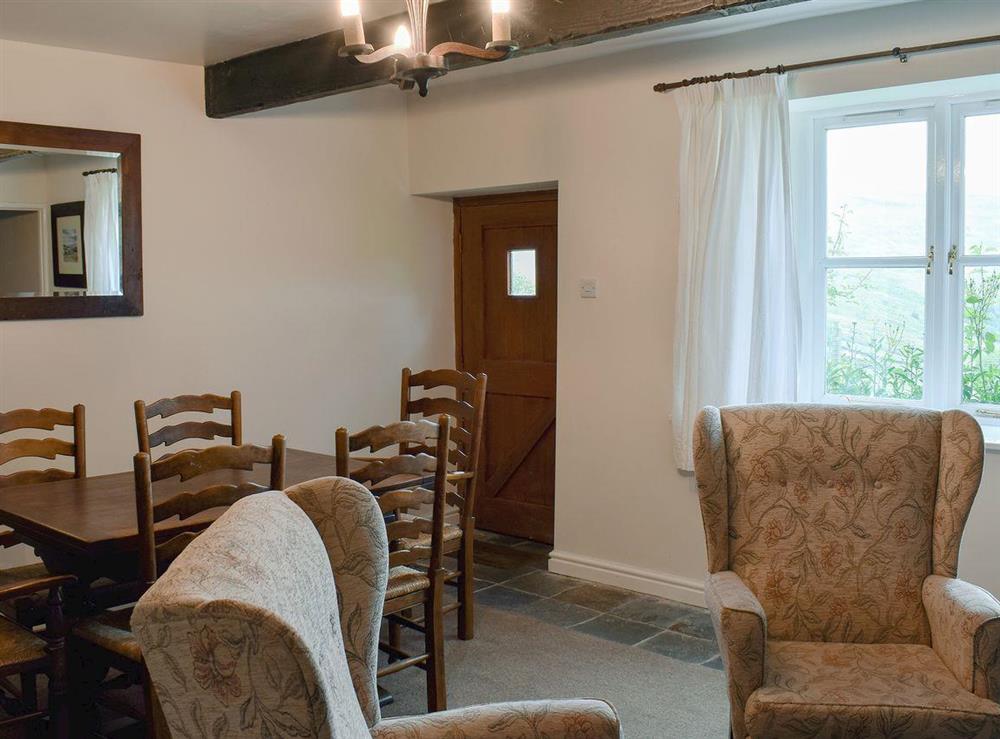Dining room with beamed ceiling at East Cottage in Booze, near Reeth, North Yorkshire