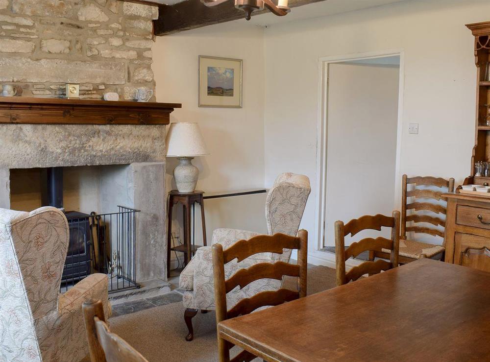 Dining room with wood burner at East Cottage in Booze, near Reeth, North Yorkshire