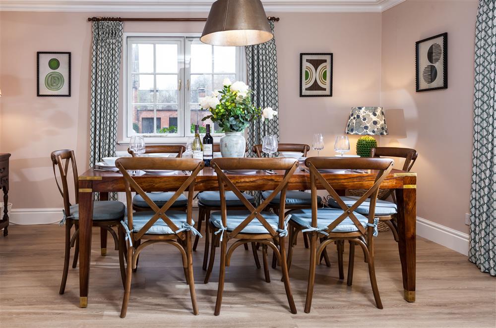 Dining room with stunning wooden table seating eight guests at East House, Arley