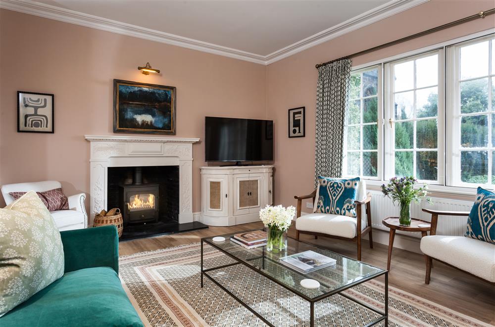 Elegant sitting room with wood burning stove at East House, Arley