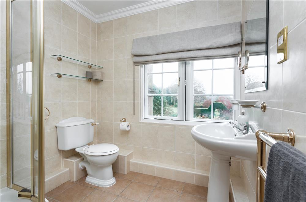 Family shower room with walk-in shower and heated towel rail at East House, Arley