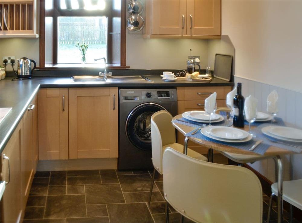 Fully equipped kitchen with dining area at East Lodge in Islesteps, near Dumfries, Dumfriesshire