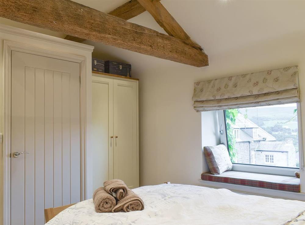 Characterful exposed wood beams within the en-suite double bedroom at Easter Cottage in Bamford, near Hope Valley, Derbyshire