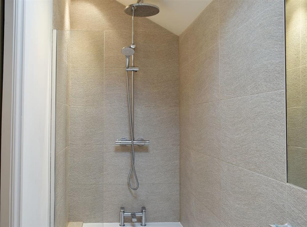 En-suite bathroom with shower over the bath at Easter Cottage in Bamford, near Hope Valley, Derbyshire