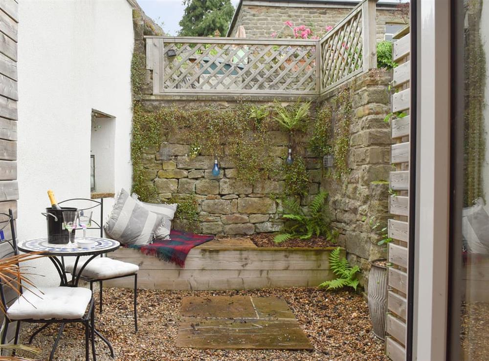 Enclosed courtyard with outdoor furniture at Easter Cottage in Bamford, near Hope Valley, Derbyshire