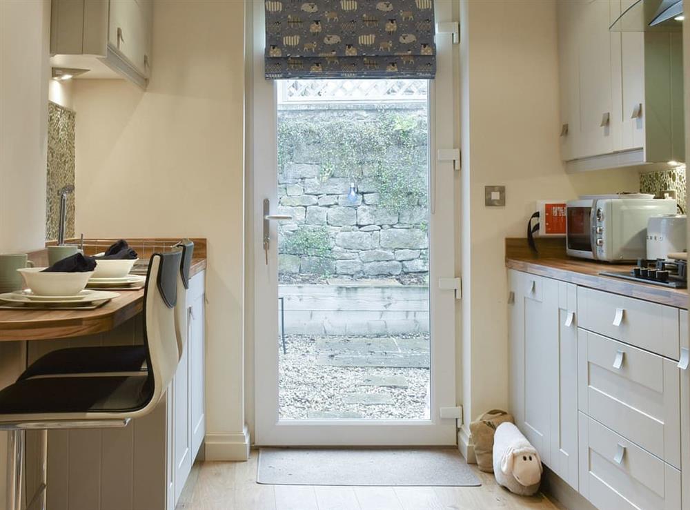 Kitchen with door to courtyard at Easter Cottage in Bamford, near Hope Valley, Derbyshire