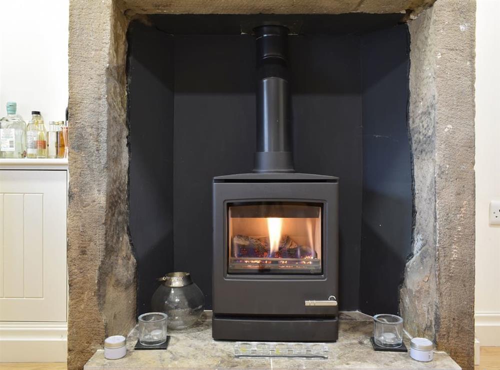 Warming wood-burner style gas fire at Easter Cottage in Bamford, near Hope Valley, Derbyshire