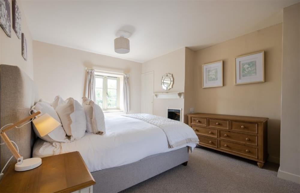 First floor: Master bedroom with a king-size bed at Eastgate Cottage and Hideaway, Salthouse near Holt