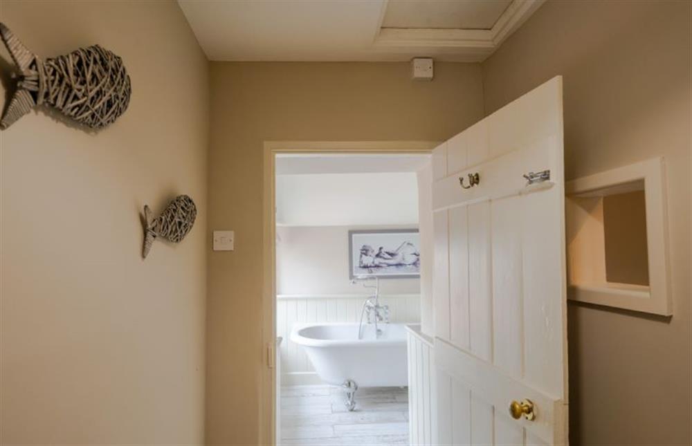 First floor: The family bathroom with roll-top bath at Eastgate Cottage and Hideaway, Salthouse near Holt