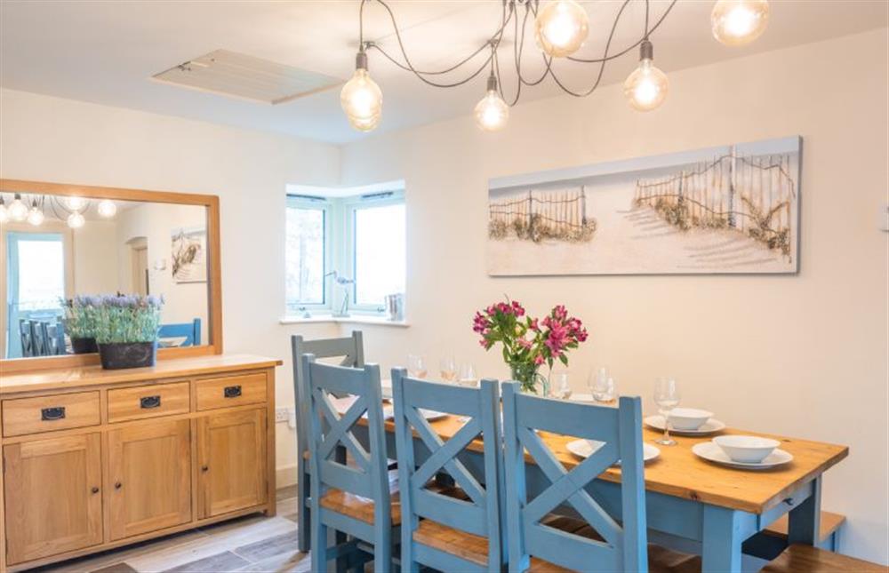 Ground floor: The dining table has chairs and a bench at Eastgate Cottage and Hideaway, Salthouse near Holt