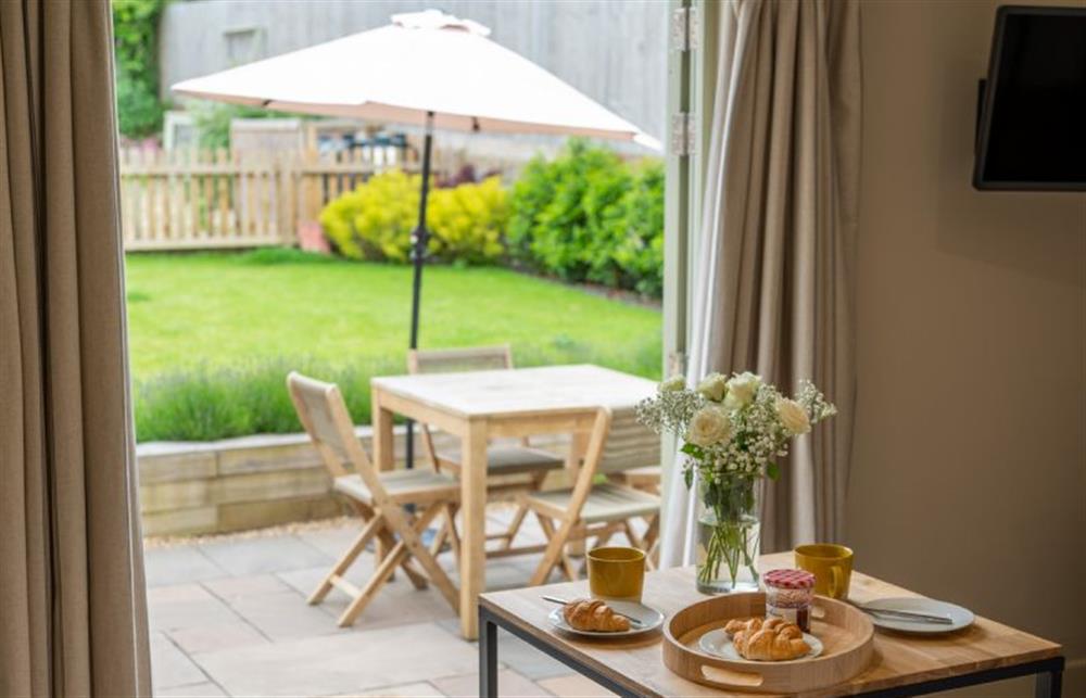 Ground floor: French doors lead onto the front terrace and garden at Eastgate Hideaway, Salthouse near Holt