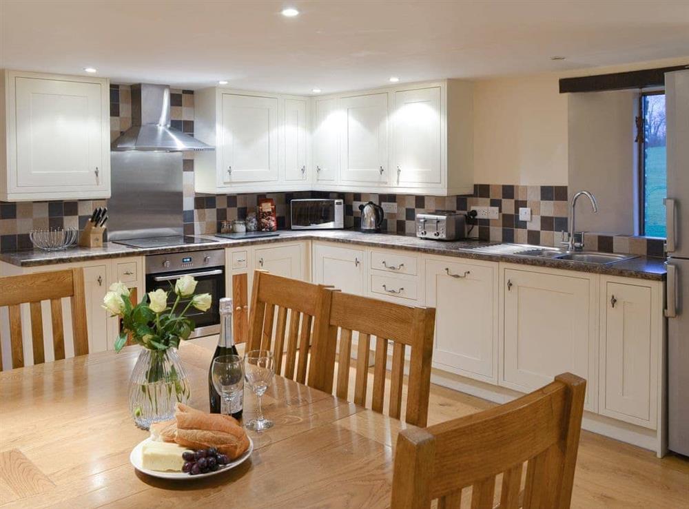 Well-equipped kitchen with convenient dining area at Tawny Owl, 