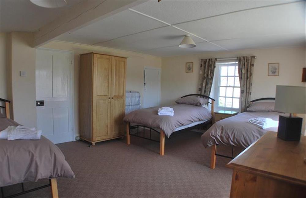 bedroom three, large room with three single beds at Eaton Cottage, Thornham near Hunstanton
