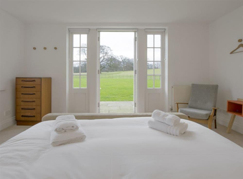 Ground floor double bedroom with French doors to garden at Eden in Broughton, near Skipton, North Yorkshire
