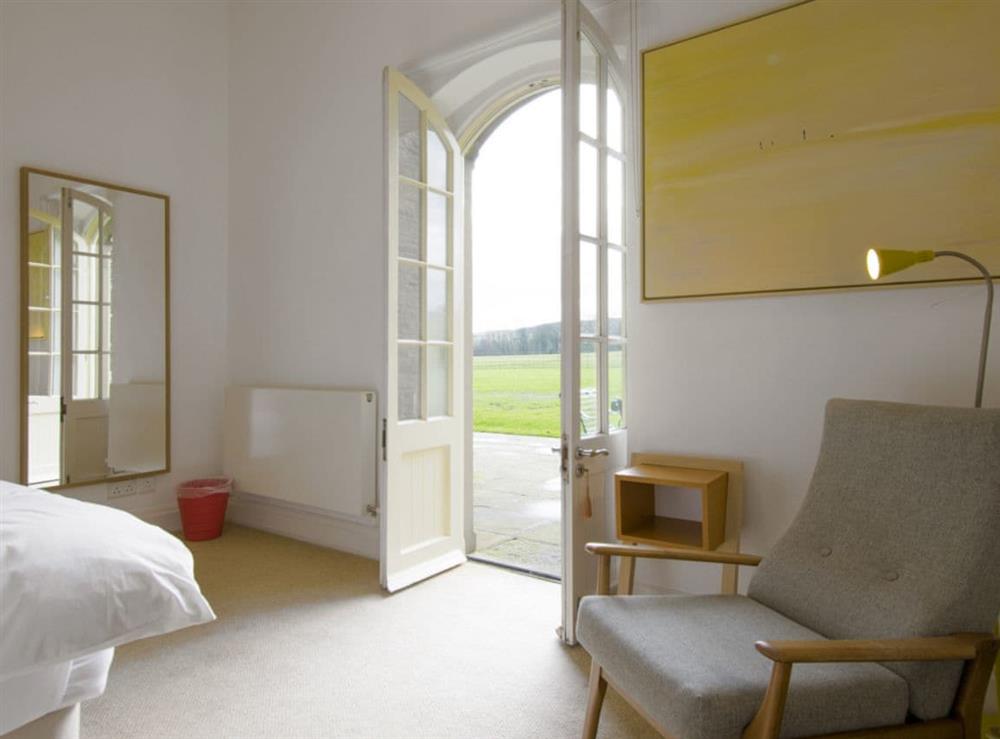 Ground floor twin bedroom with French doors to patio area and garden at Eden in Broughton, near Skipton, North Yorkshire