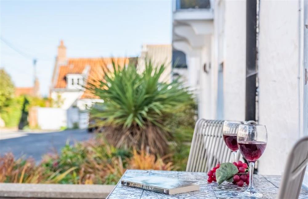 A glass of wine while you take in the view of Chapel Yard at Eden Cottage, Wells-next-the-Sea