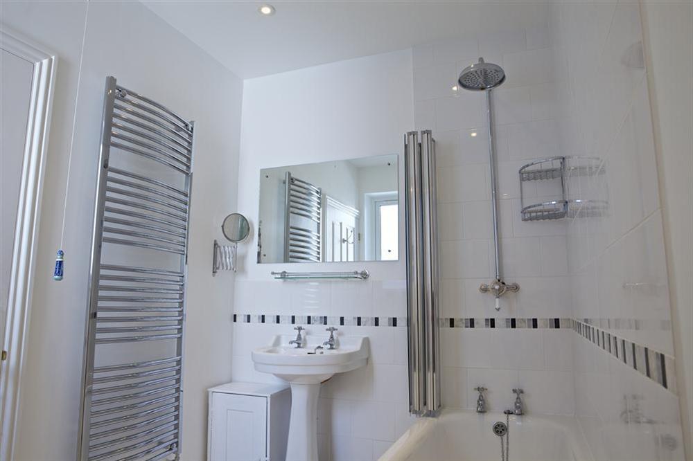 Modern bathroom with bath and rainforest shower over at Edinburgh House in , Salcombe
