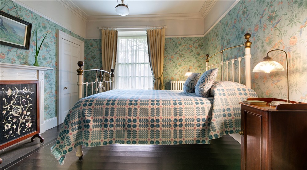 A double bedroom with antique brass/iron bed at Egryn in Nr Barmouth, Gwynedd