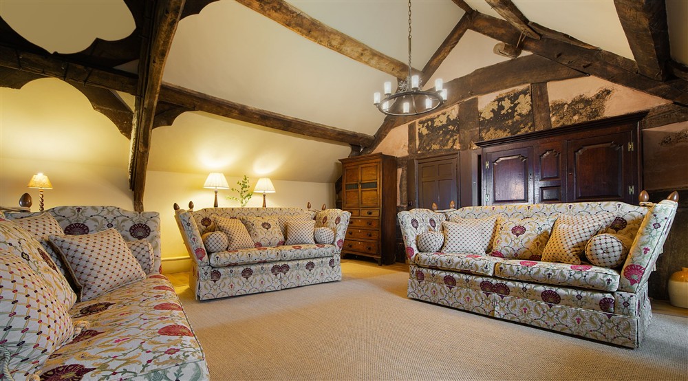 The medieval hall sitting room on the first floor of Egryn. The room has a vaulted ceiling, wooden beams, three sofas, a television and a small dining table, Gwynedd (photo 2) at Egryn in Nr Barmouth, Gwynedd