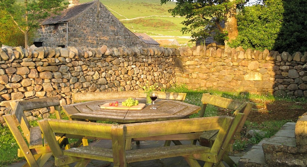 The rear garden area with picnic table at Egryn in Nr Barmouth, Gwynedd