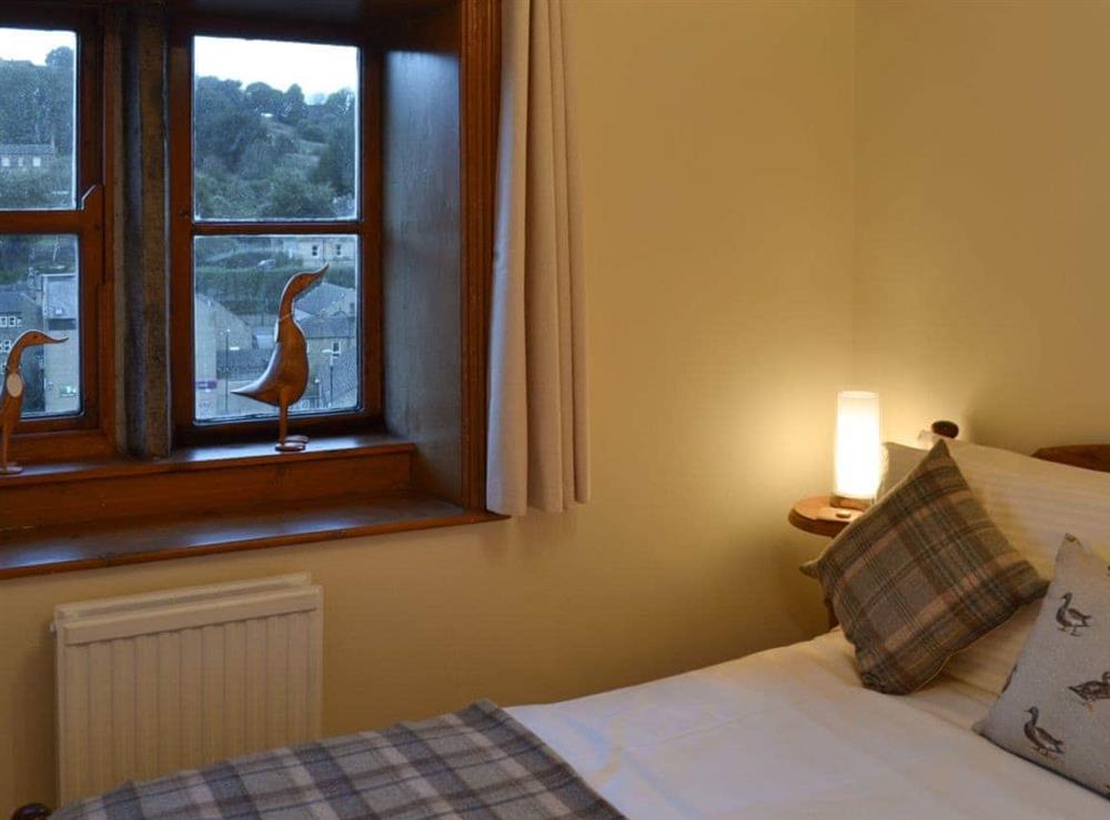 Double bedroom with mullioned at Eider Cottage in Holmfirth, West Yorkshire