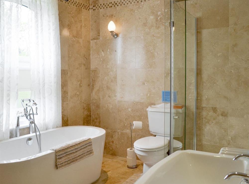 Family bathroom with bath and separate shower cubicle at The Gatehouse, 