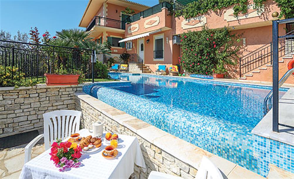 Swimming pool and seating at Eleni, Kalami Corfu, Greece
