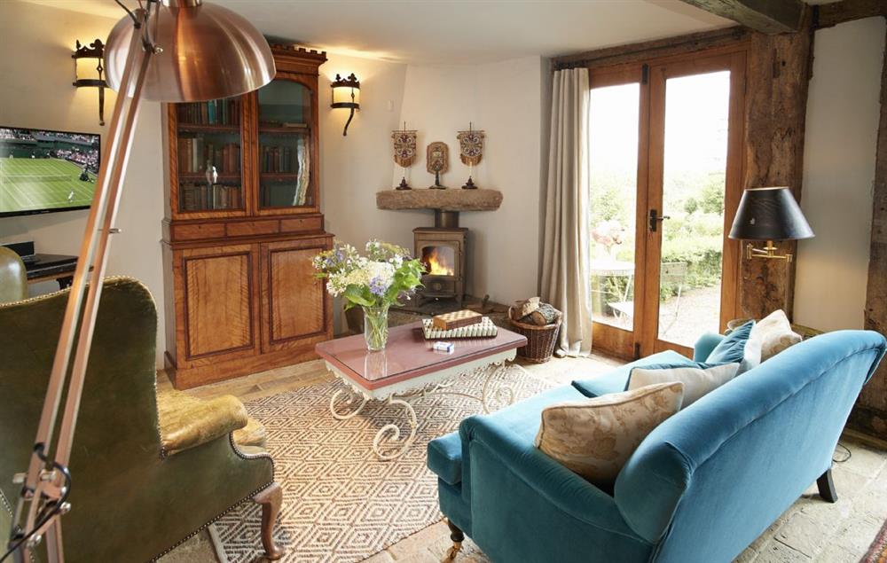 The sitting room has French doors with views out onto the sunken garden, with tables and chairs outside