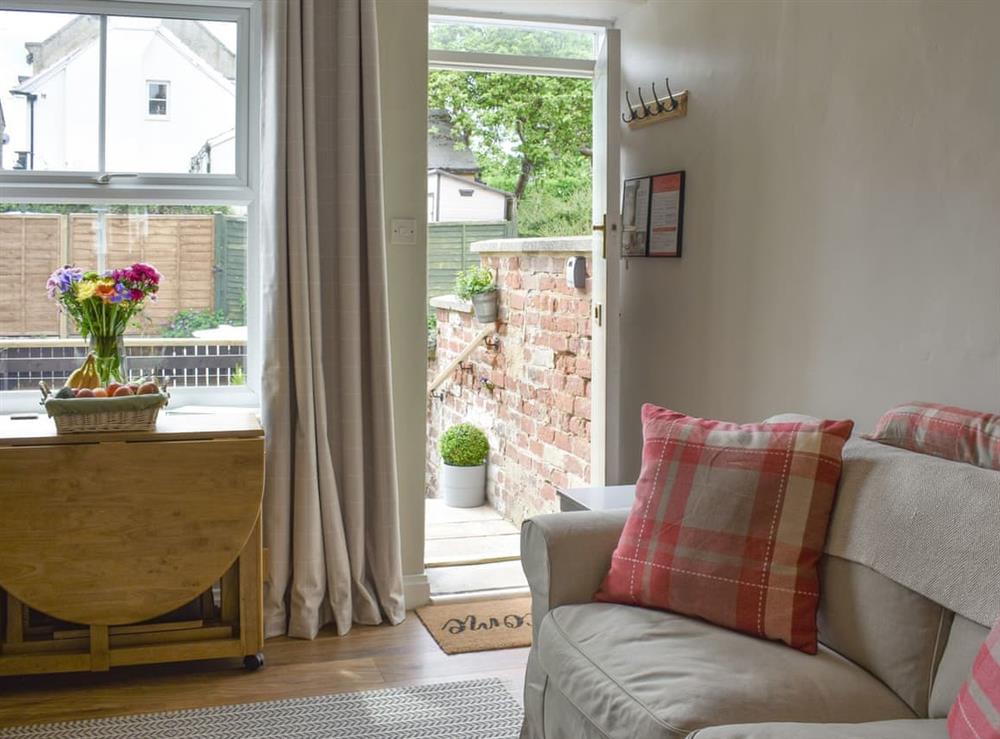 Cosy living room with access to patio area at Elizabeth Cottage in Hinderwell, near Whitby, North Yorkshire