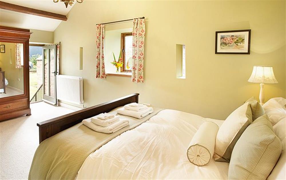 Double bedroom (5’) with antique linen fold carved bed at Elk Cottage, Glassonby