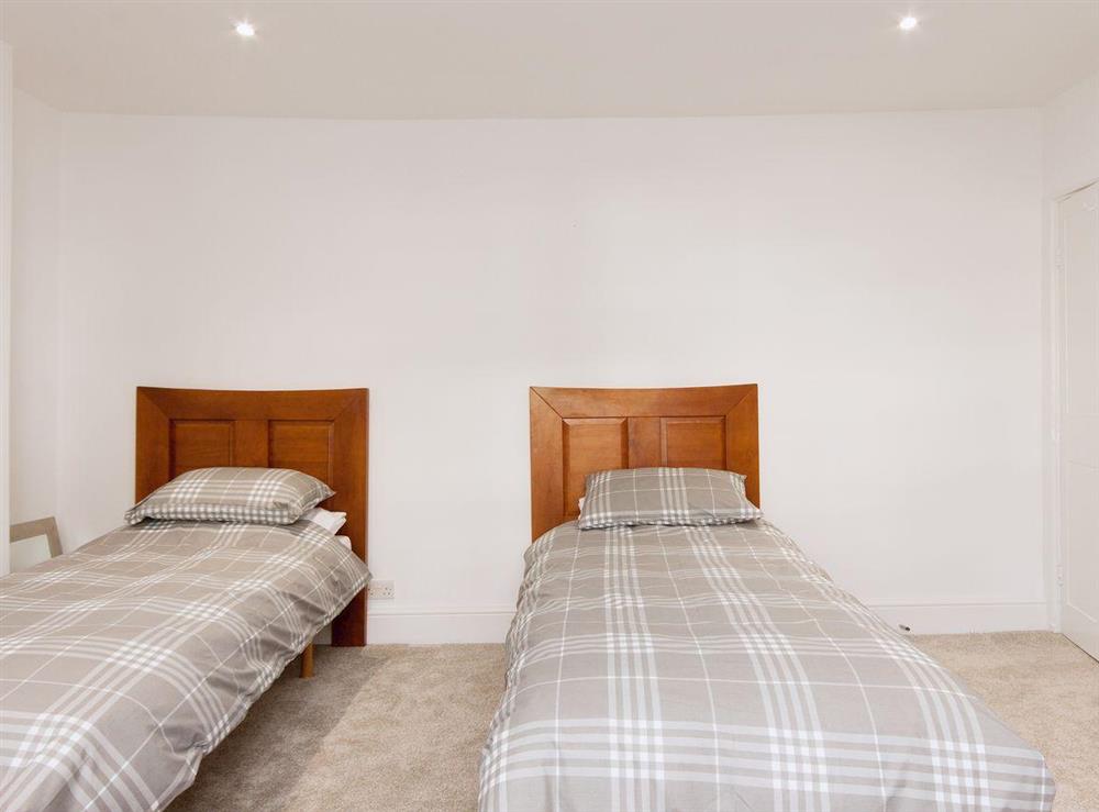 A cosy twin bedded room finishes off the bedrooms at Elm Grove in Dartmouth, Devon