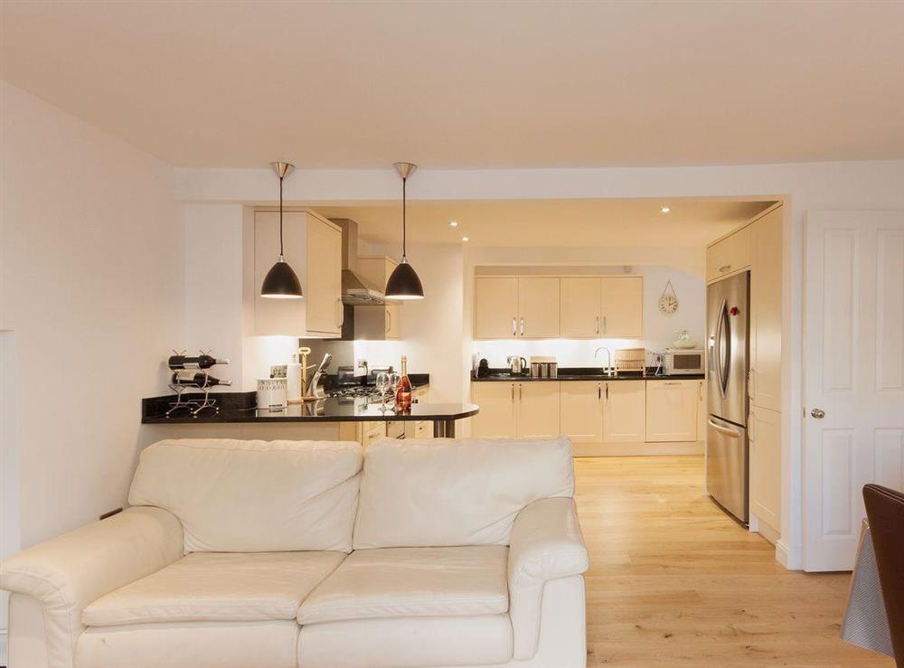 Leather sofas add to the contemporary, luxury feel of the dining area at Elm Grove in Dartmouth, Devon