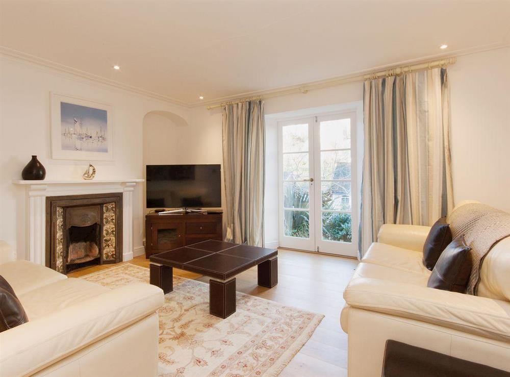 Lovely living room with feature fireplace, wooden floors and satellite television at Elm Grove in Dartmouth, Devon