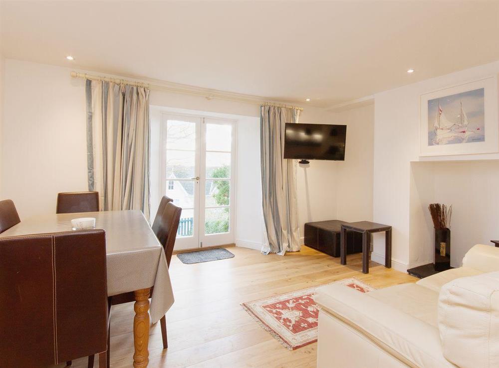 Practical and spacious the dining area/kitchen also has wooden floors at Elm Grove in Dartmouth, Devon