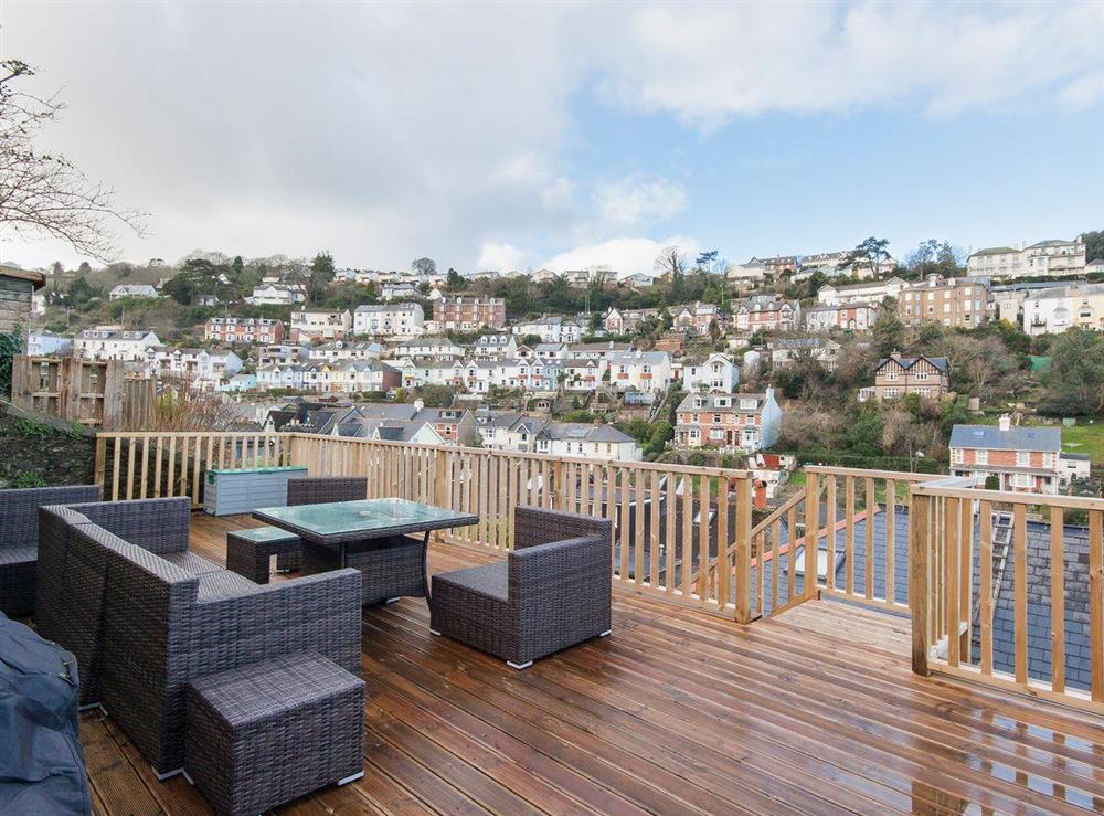 The decked area has modern patio furniture at which you can sit and have an al fresco meal whilst overlooking the town at Elm Grove in Dartmouth, Devon