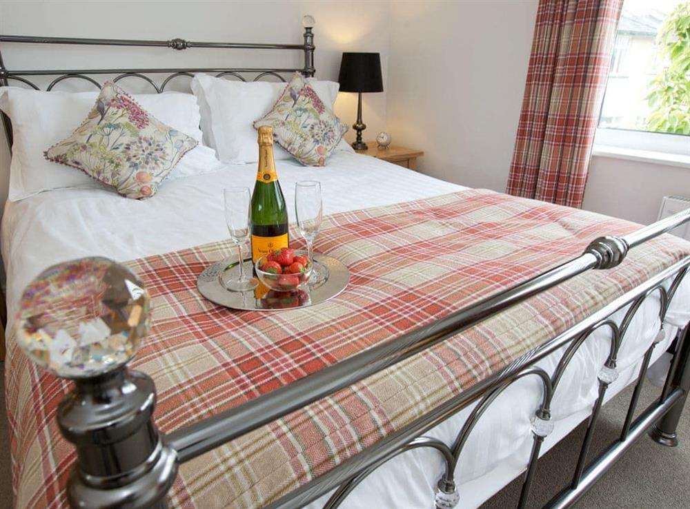 Comfortable double bedroom with en-suite shower room at Elmcot in Keswick, Cumbria