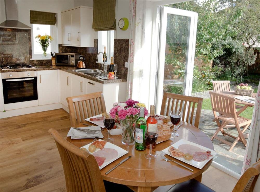 Dining area convenient to kitchen and garden at Elmcot in Keswick, Cumbria