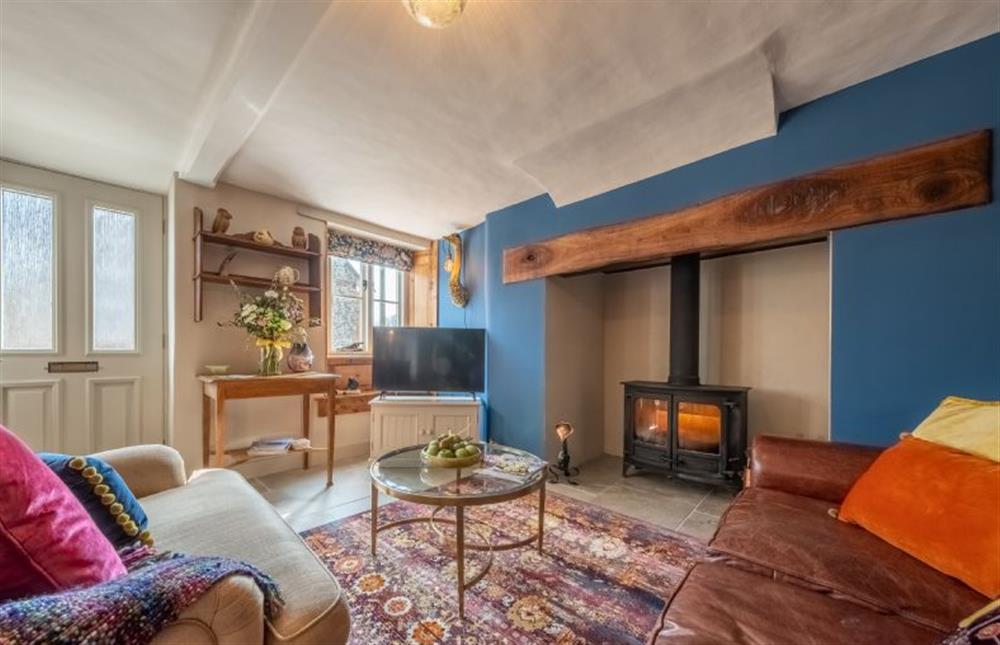 Ground floor: A pretty sitting room with warm colours at Ember Cottage, Litcham near Kings Lynn