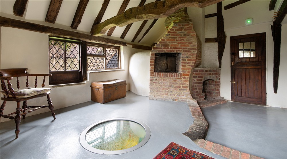 The bake room with original well at Emley Farmhouse in Godalming, Surrey